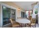 Covered patio area features a round table with seating for four at 7658 Whisper Way # 202, Reunion, FL 34747