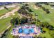 Resort-style pool with surrounding lounge chairs and golf course views at 7658 Whisper Way # 202, Reunion, FL 34747