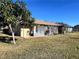 Back exterior of home with sunroom and landscaping at 812 Park Villa Cir, Orlando, FL 32824