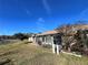 Back exterior view showing a sunroom and grassy lawn at 812 Park Villa Cir, Orlando, FL 32824