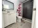 Updated bathroom with white vanity and dark gray shower tile at 812 Park Villa Cir, Orlando, FL 32824