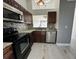 Modern kitchen features granite countertops, stainless steel appliances, and wood cabinets at 812 Park Villa Cir, Orlando, FL 32824