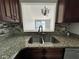 Kitchen features granite countertops and stainless steel sink at 812 Park Villa Cir, Orlando, FL 32824