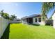 Large backyard with putting green, solar panels, and privacy fence at 9067 Arbors Edge Trl, Windermere, FL 34786