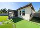 Home's backyard features a putting green, patio, and pergola at 9067 Arbors Edge Trl, Windermere, FL 34786