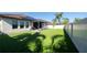 Artificial turf backyard with covered patio and privacy fence at 9067 Arbors Edge Trl, Windermere, FL 34786