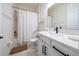 Modern bathroom with white cabinets, quartz countertop and walk-in shower at 9067 Arbors Edge Trl, Windermere, FL 34786