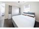 Spacious bedroom with murphy bed, built-in shelving and hardwood floor at 9067 Arbors Edge Trl, Windermere, FL 34786