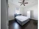 Bedroom with gray platform bed and dark hardwood floor at 9067 Arbors Edge Trl, Windermere, FL 34786