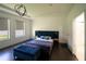 Spacious bedroom with a plush bed, large windows, and dark hardwood floors at 9067 Arbors Edge Trl, Windermere, FL 34786