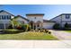 Beautiful two-story home with a well-manicured lawn and brick driveway at 9067 Arbors Edge Trl, Windermere, FL 34786