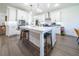 Modern kitchen with white cabinets, quartz countertops and island at 9067 Arbors Edge Trl, Windermere, FL 34786