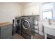 Bright laundry room with washer, dryer, and ample cabinet space at 9067 Arbors Edge Trl, Windermere, FL 34786