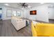 Bright living room with a large sofa and yellow accent chair at 9067 Arbors Edge Trl, Windermere, FL 34786