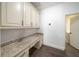 Home office with built-in cabinetry and granite countertop at 9067 Arbors Edge Trl, Windermere, FL 34786