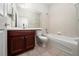 Bathroom with tub, toilet and wood vanity at 9434 Myrtle Creek Ln # 914, Orlando, FL 32832