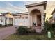 Tan house with white garage door, red brick driveway and landscaping at 9720 Bucklow Hill Dr, Orlando, FL 32832