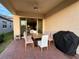 Covered patio with table and chairs, and a grill at 9720 Bucklow Hill Dr, Orlando, FL 32832