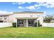 Expansive backyard featuring a screened-in patio and lush green lawn perfect for outdoor living and entertaining at 9786 Lake District Ln, Orlando, FL 32832