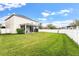 Spacious fenced backyard with a screened patio, providing ample room for outdoor activities and relaxation at 9786 Lake District Ln, Orlando, FL 32832