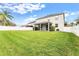 Large, well-maintained backyard with a white fence and a screened lanai offers privacy and space for recreation at 9786 Lake District Ln, Orlando, FL 32832