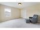 Spare bedroom with a sitting chair, ottoman and a double door closet at 9786 Lake District Ln, Orlando, FL 32832