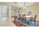 Traditional dining room featuring hardwood floors and modern decor, open to the foyer at 9786 Lake District Ln, Orlando, FL 32832