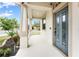 Covered front porch featuring a gray front door, white railing, and manicured landscaping at 9786 Lake District Ln, Orlando, FL 32832