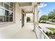 Covered front porch showcasing white railing and plenty of room to relax and enjoy the outdoors at 9786 Lake District Ln, Orlando, FL 32832