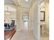 Hallway with tile flooring that offers access to the dining room, powder room, and other areas of the home at 9786 Lake District Ln, Orlando, FL 32832