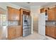 Open kitchen featuring stainless steel appliances, custom cabinets, and adjacent pantry at 9786 Lake District Ln, Orlando, FL 32832