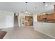 Open kitchen with stainless steel appliances, a breakfast bar, and access to living areas and staircase at 9786 Lake District Ln, Orlando, FL 32832