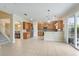 Open-concept kitchen with stainless steel appliances, wood cabinets, and a breakfast bar at 9786 Lake District Ln, Orlando, FL 32832