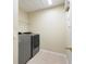 Laundry room featuring updated washer and dryer machines, tiled floor and storage at 9786 Lake District Ln, Orlando, FL 32832