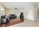 This spacious living room features hardwood floors, a ceiling fan, and a staircase at 9786 Lake District Ln, Orlando, FL 32832