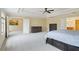 Spacious main bedroom with a tray ceiling, ceiling fan, and dark wood furniture at 9786 Lake District Ln, Orlando, FL 32832