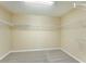 Walk-in closet with ample shelving and carpeted floor, ready for storage at 9786 Lake District Ln, Orlando, FL 32832