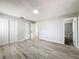 Bright bedroom featuring a spacious layout, ample closet space, and light gray, wood-look flooring at 980 Pinecrest Dr, Bartow, FL 33830