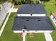 Aerial view of a two homes with black shingle roofs and green lawns at 1022 Mack Ave, Orlando, FL 32805