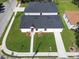 Aerial view of a home with a black shingle roof and green lawn at 1022 Mack Ave, Orlando, FL 32805