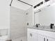 Bathroom with white dual vanity, granite countertop, black fixtures, and a shower at 1022 Mack Ave, Orlando, FL 32805