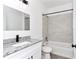 Bathroom with white vanity, granite countertop, black fixtures, and a shower and tub combination at 1022 Mack Ave, Orlando, FL 32805
