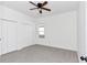 This bedroom features carpet, neutral walls, a ceiling fan, a window, and closet storage at 1022 Mack Ave, Orlando, FL 32805