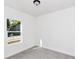 Cozy bedroom featuring carpeting, neutral paint, and a window offering natural light at 1022 Mack Ave, Orlando, FL 32805