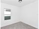 This neutral bedroom has carpet and a window at 1022 Mack Ave, Orlando, FL 32805