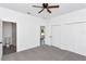 This bedroom features carpet, neutral walls, a ceiling fan, and closet storage at 1022 Mack Ave, Orlando, FL 32805