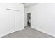 Bedroom with neutral walls and carpeting, a window, and closet storage at 1022 Mack Ave, Orlando, FL 32805
