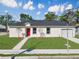 Charming single Gathering home with an expansive lawn, concrete sidewalk, and an attached garage at 1022 Mack Ave, Orlando, FL 32805