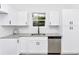 Close up of kitchen featuring granite countertops, stainless steel appliances, and white cabinets at 1022 Mack Ave, Orlando, FL 32805
