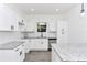 Updated kitchen with stainless steel appliances, granite countertops, and crisp white cabinetry at 1022 Mack Ave, Orlando, FL 32805